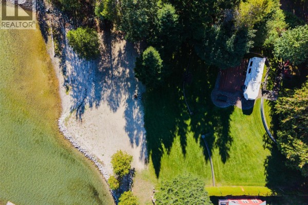 Top-down perspective showing a beach, trees, a trailer on a deck, and part of a red house. - Lot 1 Lower Six Mile Road, Nelson