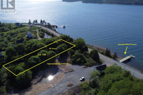 Aerial view of a waterfront lot marked with yellow boundaries, showing ocean access and a wharf. - Lot 104 Peggys Cove Road, French Village
