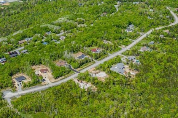 Aerial view showing a mix of cleared lots and wooded areas along a winding road. - Lot 112 Moonlight Drive, Mount Uniacke