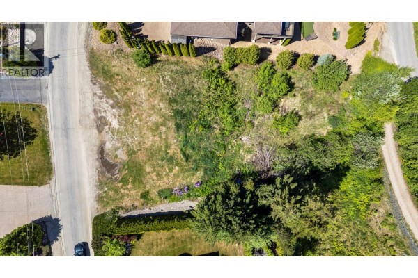Aerial view of a cleared lot with surrounding vegetation and a street. - Lot 117 Golf Course Drive, Blind Bay