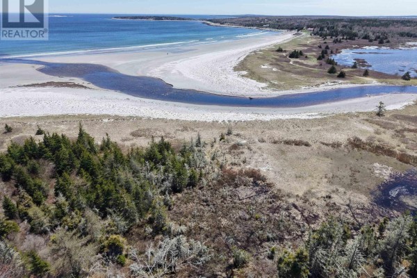 Aerial view of forested land with a yellow star, marking the property with a large lake in background. - Lot 12 Cross Road, Roseway