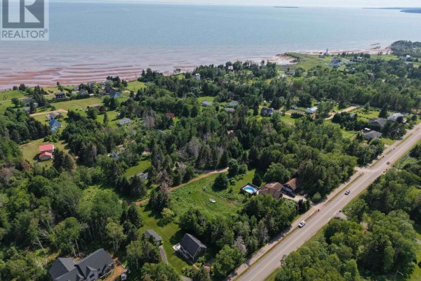 Aerial view of residential properties and mature trees with the ocean visible in the distance. - Lot 1&2 Keppoch Road, Stratford