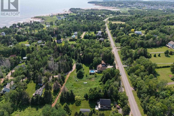 Aerial view of Keppoch Road showing properties, trees, and the coastline with a clear blue sky. - Lot 1&2 Keppoch Road, Stratford