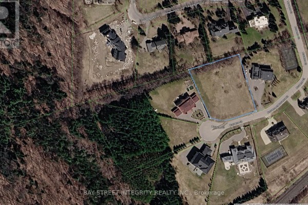 Aerial view of Lot 12 Provence Court, a cleared lot bordered by trees and homes. - Lot 12 Provence Court, Richmond Hill