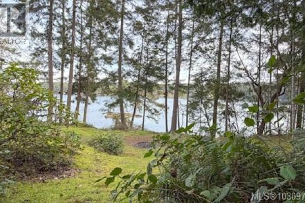 Green grass and foliage in foreground with water and trees beyond. - Lot 13 Easthom Rd, Gabriola Island