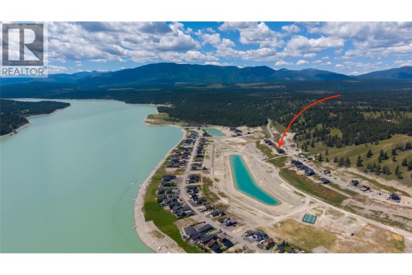 Aerial view of Lake Koocanusa and surrounding development, with red arrow on Lot 14 Marcer Road. - Lot 14 Marcer Road, Lake Koocanusa