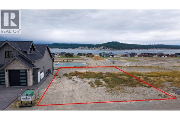 Lot 14 Marcer Road property boundary marked in red, adjacent to a house with mountain lake view. - Lot 14 Marcer Road, Lake Koocanusa