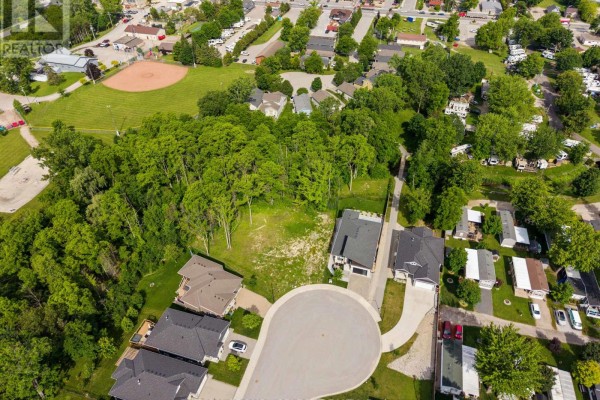 Aerial view of Lot 17 Creekside Place, showing the wooded lot and surrounding neighborhood. - Lot 17 Creekside Place, Lambton Shores