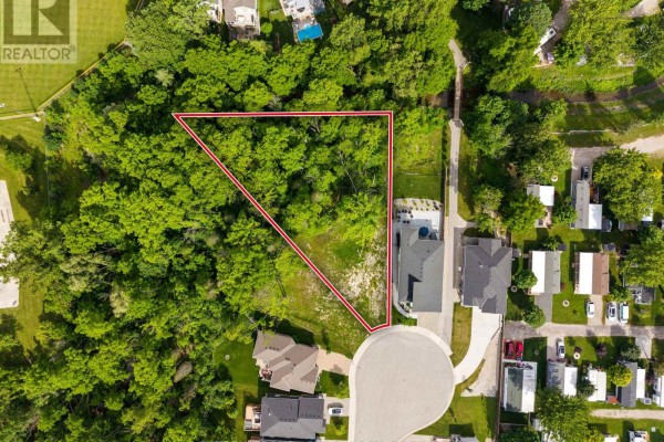 Overhead view of the triangular Lot 17 Creekside Place property with a red outline, surrounded by trees. - Lot 17 Creekside Place, Lambton Shores