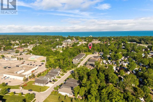 Aerial view of the Lambton Shores neighborhood, showing homes, trees, and a distant view of the lake. - Lot 17 Creekside Place, Lambton Shores