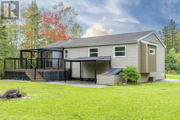 Rear exterior view of the bungalow showing a deck, screened porch, covered area, and patio. - Lot 17 Stage Road, Enfield