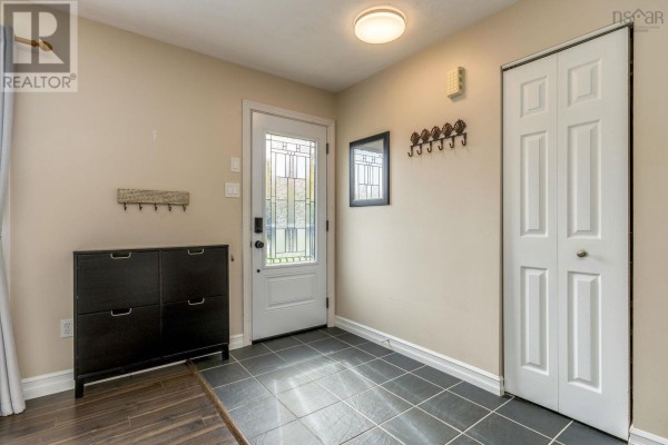 Foyer with dark grey tile floor, white door with glass insert, and a black shoe cabinet. - Lot 17 Stage Road, Enfield
