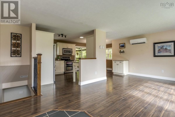 Open-concept living area showing a kitchen with white cabinets and stainless steel appliances. - Lot 17 Stage Road, Enfield