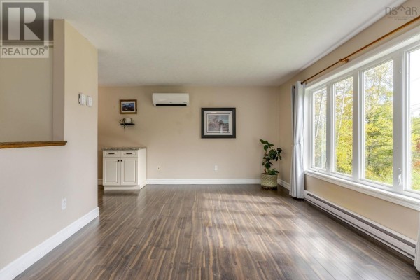 Living room with dark wood floors, large picture windows, and a white credenza. - Lot 17 Stage Road, Enfield