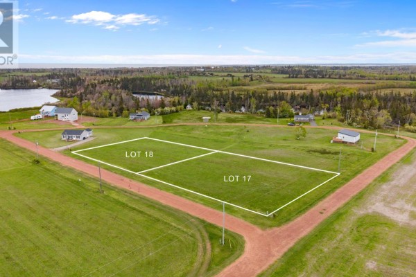 Aerial view of Lots 17 and 18, clear green land parcels with distant water and housing. - Lot 18 Majestic View Lane, Lakeside
