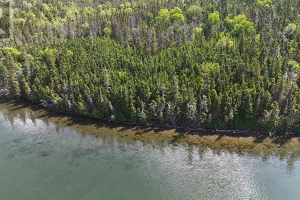 Aerial view of a large, wooded property bordering a calm blue body of water with distant islands. - Lot 18 Marine Way, South River Bourgeois