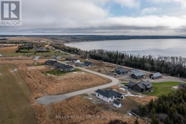 Aerial view of undeveloped land lots with red arrows pointing to Lot 18 and nearby lots on Robin Street. - Lot 18 Robin Street, Temiskaming Shores