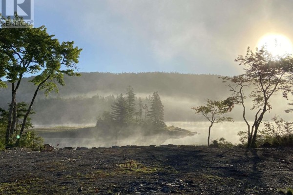 Misty morning sunrise over a calm lake with trees and an island shrouded in fog. - Lot 19 7 Highway, Goldenville