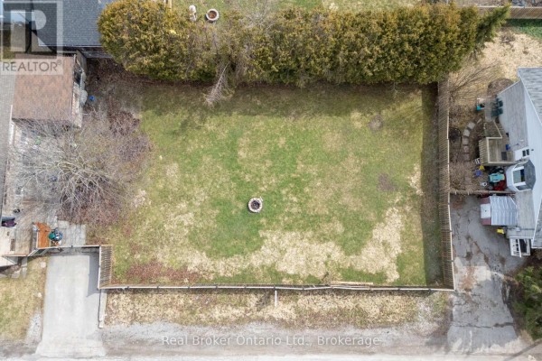 Top-down view of a square-shaped lot with a fire pit and surrounding fences. - Lot 2 & 3 - 108 Ontario Street, Clarington