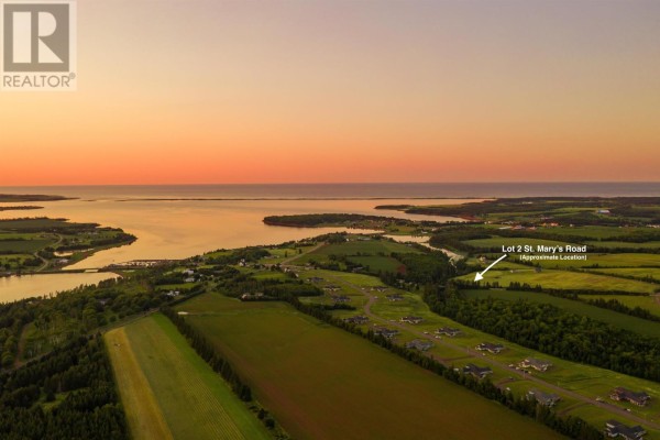 Aerial sunset view of Lot 2 St. Mary's Road property with water and distant houses. - Lot 2 St. Mary's Road, Stanley Bridge
