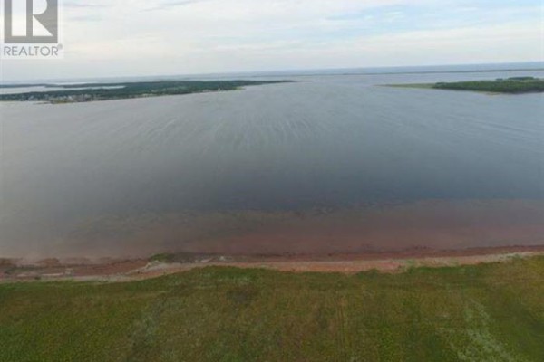 Aerial perspective of a vast water body with a shoreline and green fields. - Lot 2 Treasure Lane, Port Hill