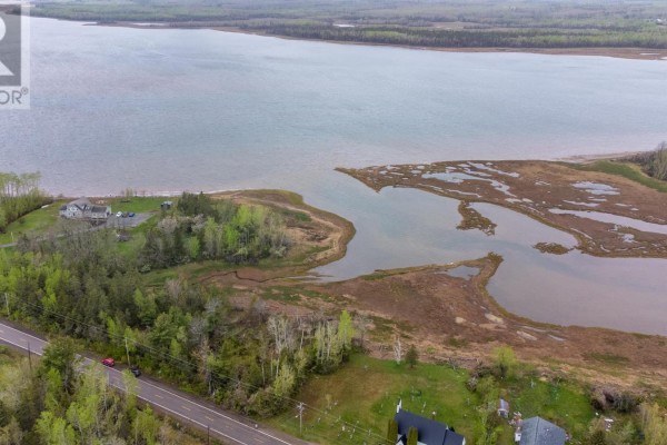 Aerial view of a bay and coastline with scattered buildings and trees along the shore. - Lot 21-1 & 21-2 Highway 6, Wallace