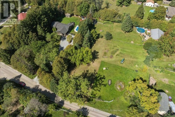 Aerial view of a property with a house, pool, and large green space. - Lot 21 Part 1 Polva Promenade, Georgina