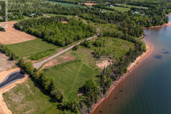 Aerial view of waterfront property with fields, trees, and shoreline. - Lot 22-17 White Pine Lane, Brudenell