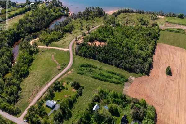 Aerial view of property with water, trees, fields, and roads. - Lot 22-17 White Pine Lane, Brudenell