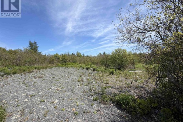 Open, cleared area with gravel and scattered green brush under a blue sky. - Lot 22-3 Wallace Bridge Station Road, Wallace River West
