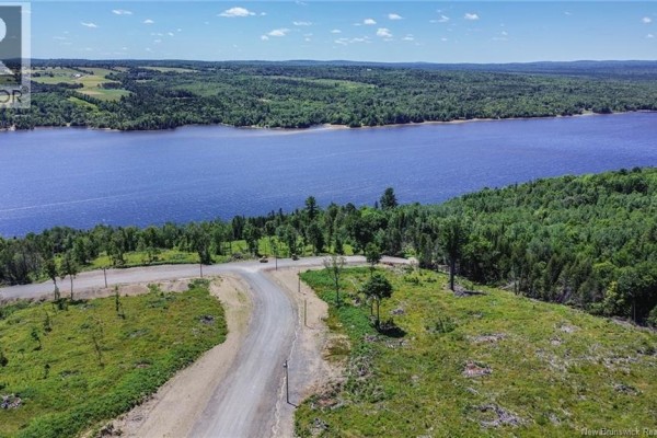 Aerial shot of a road leading to a river, with rolling hills and trees in the background. - Lot 22-33 Route 616, Keswick Ridge