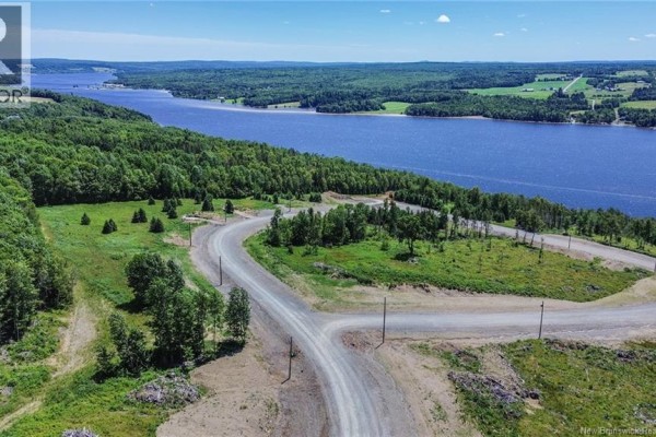 Aerial shot of land with a road, trees, and river, highlighting the terrain. - Lot 22-34 Route 616, Keswick Ridge