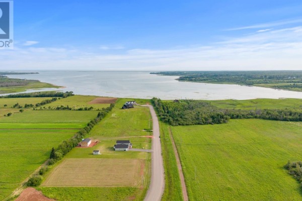 Aerial view of a rural landscape with scattered homes and a large body of water under a blue sky. - Lot 22-6 Lorraine Lane, Mount Stewart