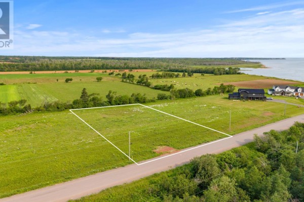Aerial view of a grassy parcel of land outlined in white, bordered by a road and green fields. - Lot 22-6 Lorraine Lane, Mount Stewart