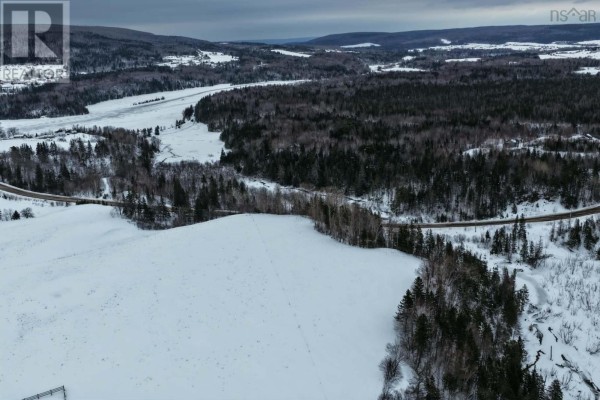 Snowy fields and forest alongside a road with a creek in a rural landscape. - Lot 24-3 Rankinville Road, Mabou
