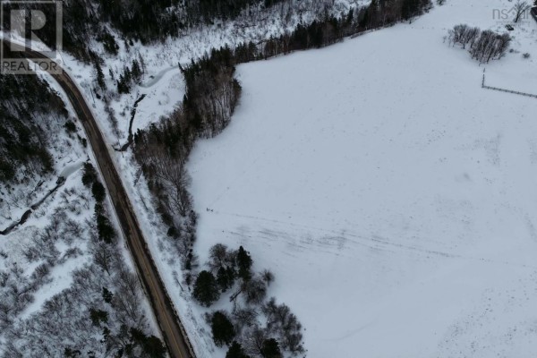 Overhead view of a road next to a large snowy field and bare trees. - Lot 24-3 Rankinville Road, Mabou