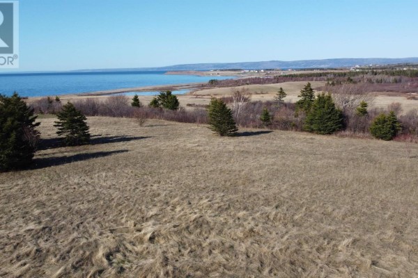 Snowy landscape featuring trees and distant homes, with a frozen ocean view - Lot 24 Cape Jack Road, Cape Jack