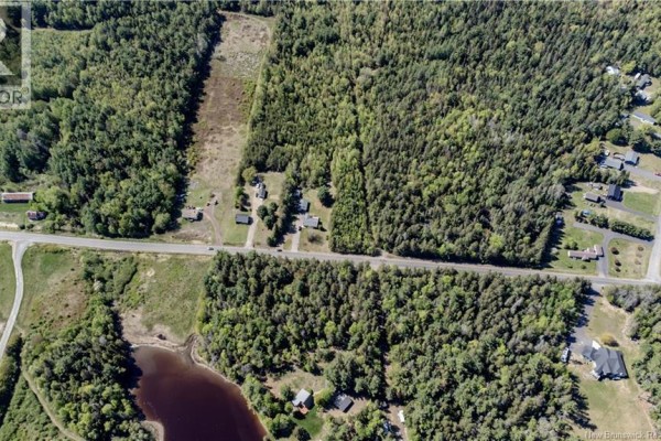 Panoramic aerial view of a vast landscape with a lake, dense forests, and scattered buildings under a blue sky. - Lot 25-1 St-charles N, Saint Charles