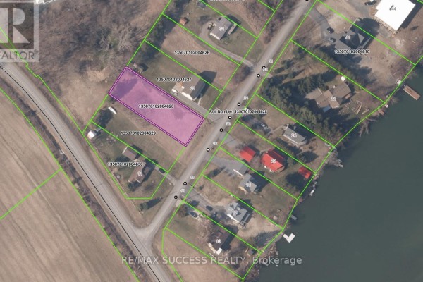 Aerial view of the lot outlined in pink, surrounded by other properties and roads. - Lot 28 Marysburgh Court, Prince Edward County