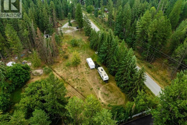 Aerial shot of the property with trailers, surrounded by greenery and a nearby road. - Lot 3, Plan Nep83874, District Lot 8, Windermere