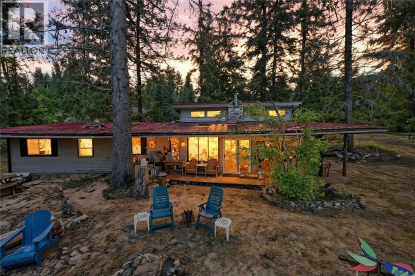 Overhead aerial view of a forested property with multiple cabins and docks on the lake. - Lot 3 Queest N. Bay, Sicamous