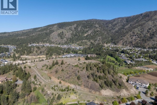 Elevated view of undeveloped land with a scenic backdrop of mountains and homes. - Lot 3 Shannon View Drive, West Kelowna