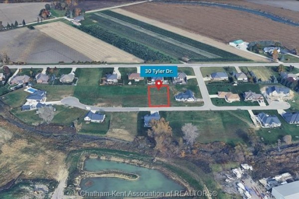 Street level view of a cleared, grassy lot with residential homes in the distance. - Lot 30 Tyler Drive, St Clair