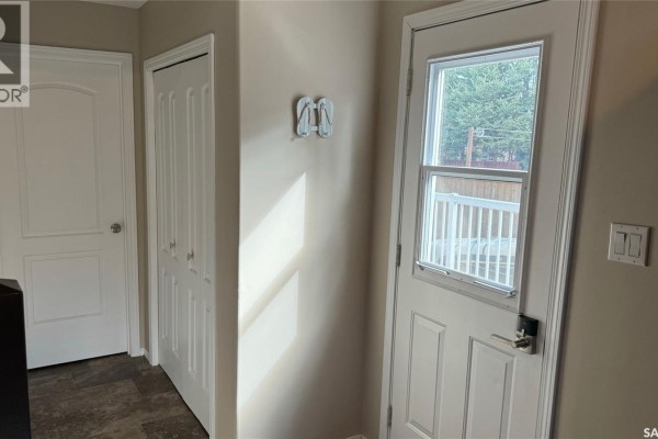 Interior hallway with a white door, a double bi-fold closet, and a white exterior door. - Lot 4 Block 4 Sturgeon Lake West, Sturgeon Lake