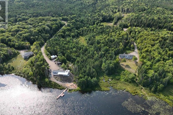 Aerial view of the property lot outlined in orange, showing cleared land and surrounding trees next to a lake. - Lot 40 Lucas Lane, Kempt Road