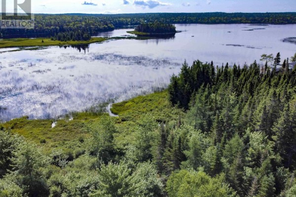 Aerial view of a wooded property with a lake, small islands, and a few scattered houses visible. - Lot 40 Lucas Lane, Kempt Road