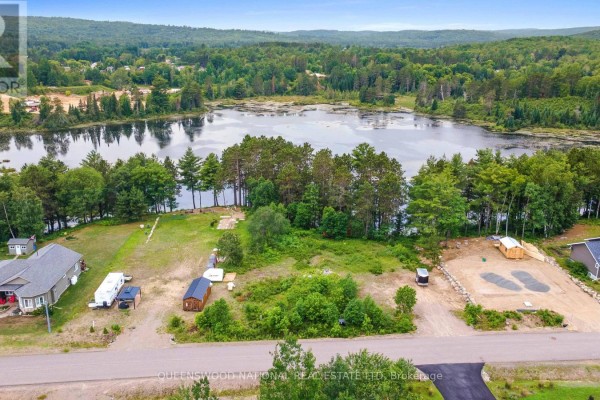 Aerial view showing multiple residential lots, a lake, and surrounding trees. - Lot 48 Lakeview Parkway, Madawaska Valley