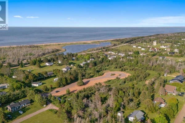 Aerial view of a lighthouse on a sandy shore next to a road and water. - Lot 5 Surf Lane, Stanhope