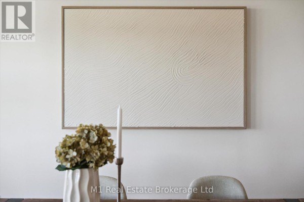 Textured white artwork hangs above a dining table with chairs. Dried hydrangeas in a vase are on the table. - Lot 51 Reids Hill Drive, Mapleton