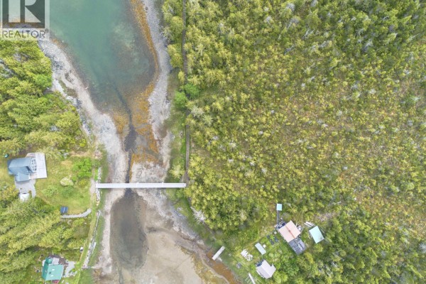 Overhead view of a waterway with adjacent land, bridge, and small buildings. - Lot 6 Hunts Inlet, Prince Rupert